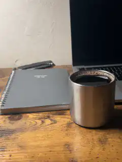 coffee cup on desk with laptop