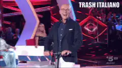Man on scooter laughing on stage