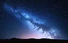 Milky Way over dark hills