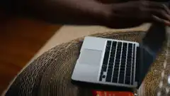 Hand closing a laptop