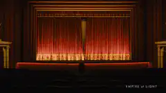 Theater curtains opening to reveal a screen