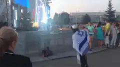 Man dancing with Israeli flag