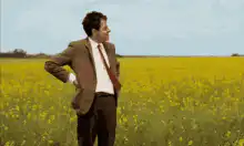 Man in field gesturing