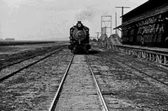 Man sitting in front of steam train