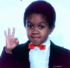 Little boy in suit showing three fingers