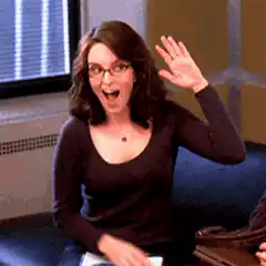 Tina Fey waving and pointing
