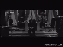 man sitting on desk then everyone falls
