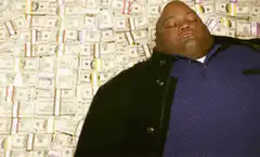 Biggie Smalls surrounded by money