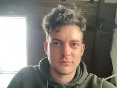 Man with messy hair looking at camera