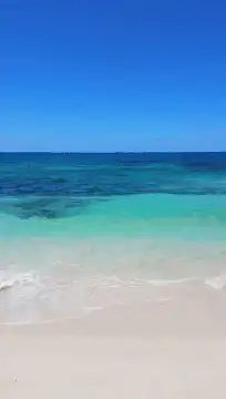 Tropical beach waves on sand
