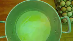 Green liquid in pot with eggs