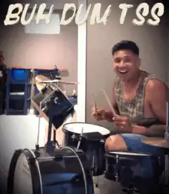 Man playing drums with buh dum tss text