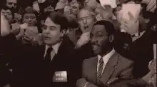 Man in crowd doing the finger