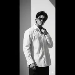 Man in white shirt and sunglasses posing