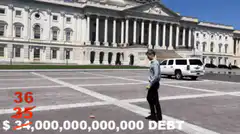 Man walking past US Treasury building with debt counter