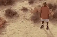 Man kicks sand in desert