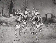 Skeletons dancing in a graveyard
