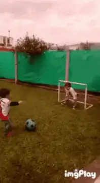 Toddler kicks soccer ball past goalie