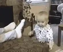 Baby smells foot and laughs