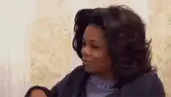 Oprah Winfrey shrugging and smiling
