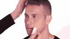 Man gets clown makeup applied