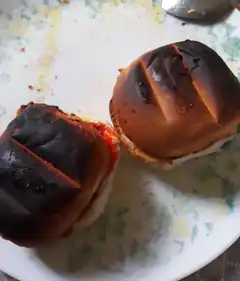 burnt burger buns on plate