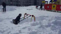 Child swinging in deep snow