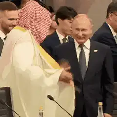 Vladimir Putin and Saudi Prince shaking hands