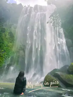 Woman sitting by a waterfall
