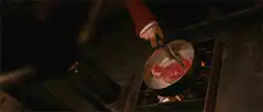 Chef flips raw meat in pan