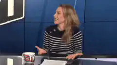 Woman shrugging at desk