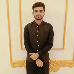 Man in black kurta standing indoors