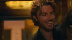 Man smiles then puts finger to lips