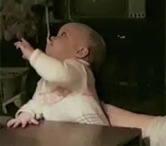 Baby with spoon on head