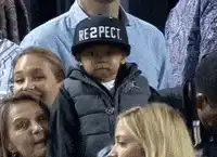 Child in RE2PECT hat at basketball game