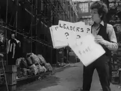Bob Dylan holding protest signs