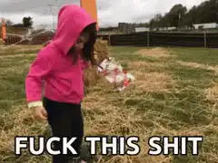 girl in pink hoodie throws doll
