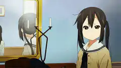 Yui and Mio sitting on a bed