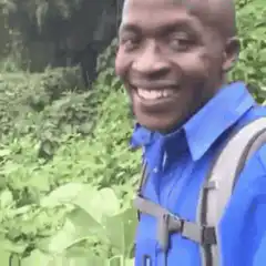 Man in blue shirt smiling okay