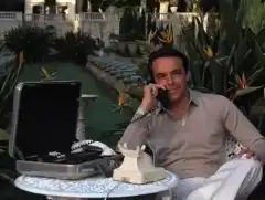 James Bond and Tony Scotti laughing on phone