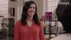 Woman in red shirt waves and says Gal Pals
