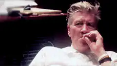 David Lynch adjusting glasses