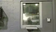 Person walking past window at night