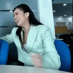 Woman in office suit laughing and dancing