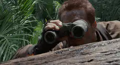 Arnold Schwarzenegger looking through binoculars
