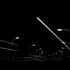 neon light streaks over street lamps