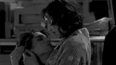 Two people kissing in black and white