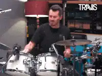 Travis Barker drumming with ba-dum-tss text