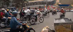 Busy street with motorcycles and bicycles