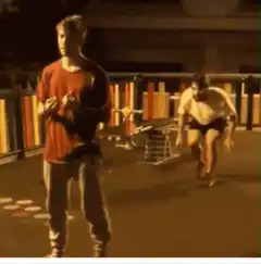 Guy in red shirt gets hit by skateboard